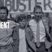 Black and white photo of the four leaders of the "Deaf President Now" protest, standing closely together outdoors with signs and buttons. "DEAF PRESIDENT NOW!" is overlaid in bold white text on the left, above the "tv+" logo. The individuals are dressed casually, suggesting a demonstration. A "BUSTERS" banner and another handwritten sign are visible behind them, with trees and a building in the background.