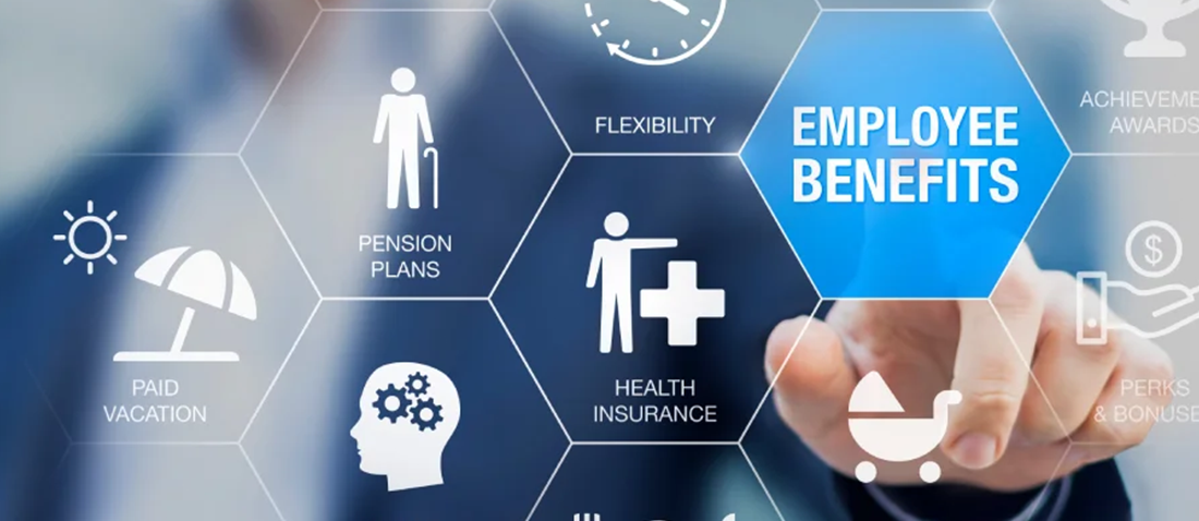 The image displays a digital infographic illustrating various employee benefits. A person's finger is touching a central hexagonal tile labeled "Employee Benefits," surrounded by other hexagonal tiles representing benefits such as paid vacation, pension plans, skills development, health insurance, parental leave, flexibility, and perks & bonuses.