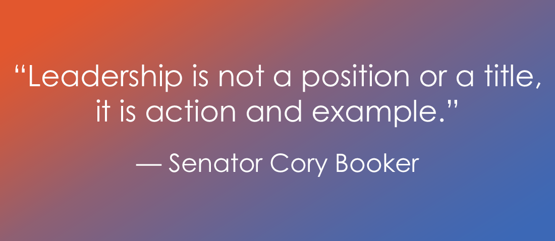 An image featuring a white text quote on a horizontal gradient background that transitions from orange on the left to purple and blue on the right. The text reads: “Leadership is not a position or a title, it is action and example.” — Senator Cory Booker